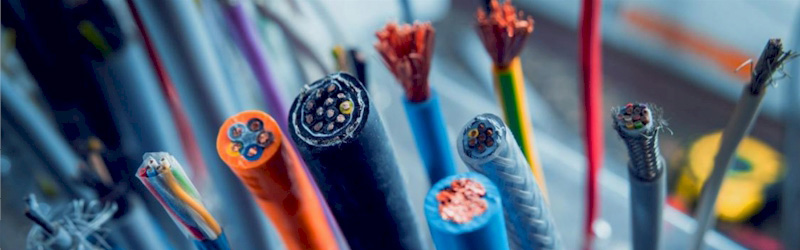 Close-up view of various network cables with exposed copper wires, representing cabling and connectivity solutions.