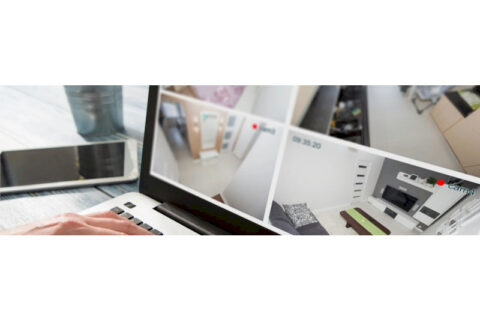 Laptop screen displaying multiple live security camera feeds, representing surveillance and monitoring systems