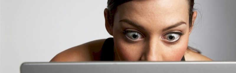 Person using a laptop, representing online security and virus protection.