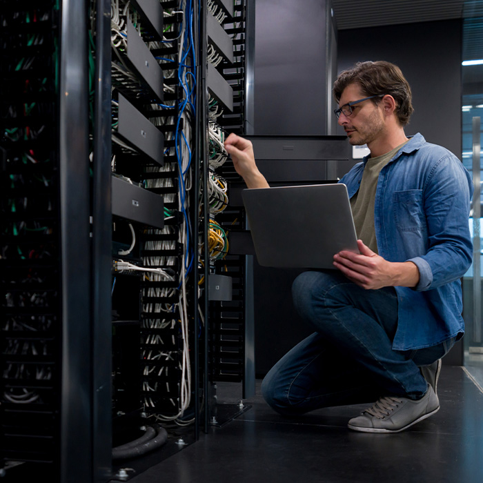 IT support technician fixing a network server
