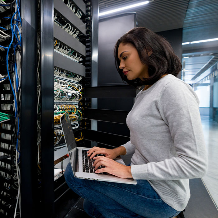 IT support technician fixing a network server at an office